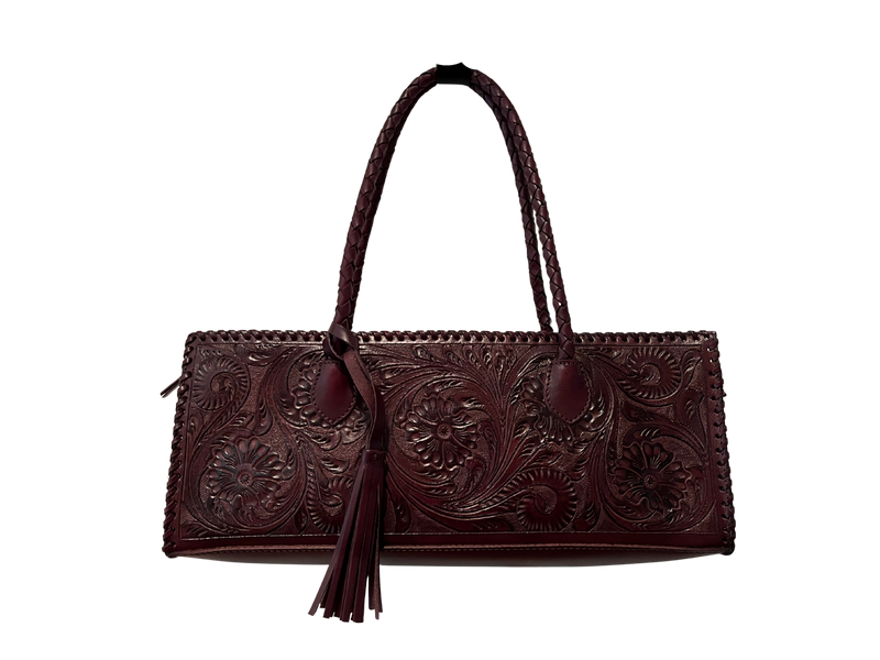 Brown leather handbag with intricate patterns on a white background