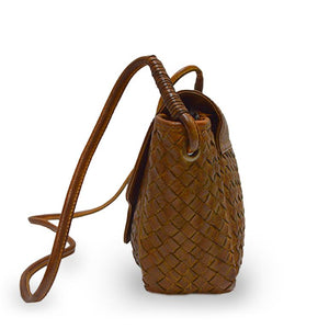 Side of brown woven leather bag with smooth flap, Sawyer Woven Shoulder Bag.