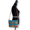 Anabaglish Yana Crossbody bag in blue  on a a mannequin, side view. 