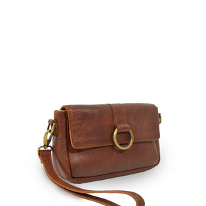 Small leather crossbody bag with a brass ring on the front, clutch at an angle, Sabrina Crossbody Bag.