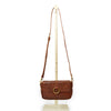 Small leather crossbody bag with a brass ring on the front handle up, Sabrina Crossbody Bag.
