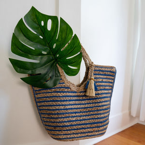 Jute bag on a door handle with a Monsterra leaf inside, Amanda Jute Tote.  