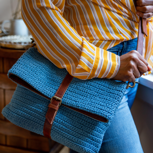 Blue cotton knit bag on a person, Yolanda Knit Foldover Crossbody Bag.