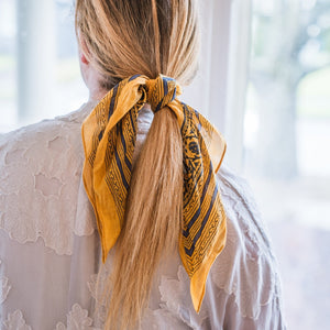 Woman with yellow scarf tied around her blonde hair, Sweet Spring Bandana.